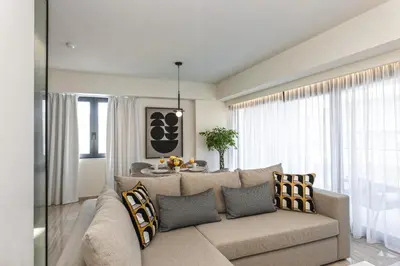 a living room with a couch and a table at Unique Icon Residence in Rhodes Town