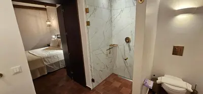 a bathroom with a shower and a toilet in it at Fournos Traditional Luxury Villa - Stegna Rhodes in Vrachonisída touArchangélou