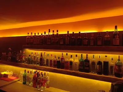 a bar with bottles of alcohol on a shelf at Casa Trees Boutique Hotel in Ixia