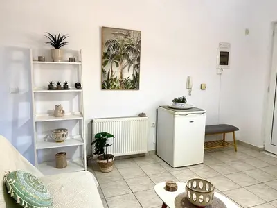 a living room with a couch and a table at Andreana s View House Rhodes in Asgourou