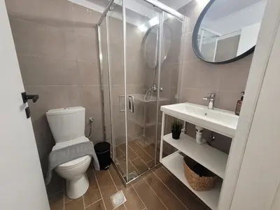 a bathroom with a shower and a toilet and a sink at Hyacinthus city apartment in Rhodes Town