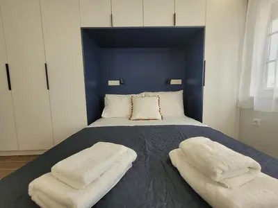 a bedroom with a bed with two pillows on it at Hyacinthus city apartment in Rhodes Town