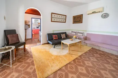 a living room with a couch and a table at Aelia Filoxenia Cottage in Afantou