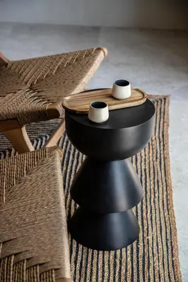 a table with two cups on top of it next to a chair at K Studios in Faliraki
