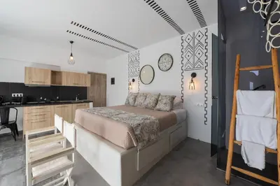 a bedroom with a bed and a kitchen at K Studios in Faliraki