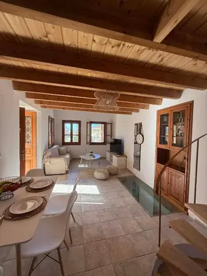 a large living room with a table and chairs at Maria's Dream House in Symi