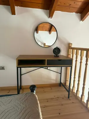 a dressing table with a mirror and a staircase at Maria's Dream House in Symi