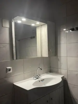 a bathroom with a sink and a mirror at Maria's Dream House in Symi
