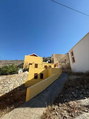 a yellow staircase in front of a building at Maria's Dream House in Symi