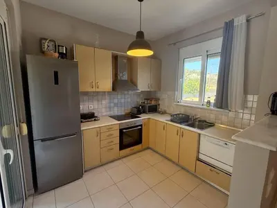 a kitchen with a stainless steel refrigerator and cabinets at Casa Fountain Villa in Kolimbia