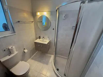 a bathroom with a shower and a toilet and a sink at Casa Fountain Villa in Kolimbia
