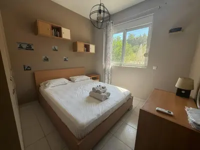 a bedroom with a bed with a teddy bear on it at Casa Fountain Villa in Kolimbia