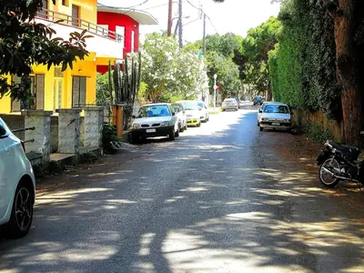 a street with cars parked on the side of the road at Palm Residence l - Islander's Home Collection in Rhodes Town