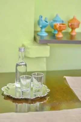 a bottle and two glasses on a plate on a table at Palm Residence l - Islander's Home Collection in Rhodes Town