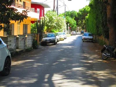 a street with cars parked on the side of the road at Palm Residence ll - Islander's Home Collection in Rhodes Town