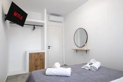 a room with a bed with towels and a mirror at maison de rivière in Afantou