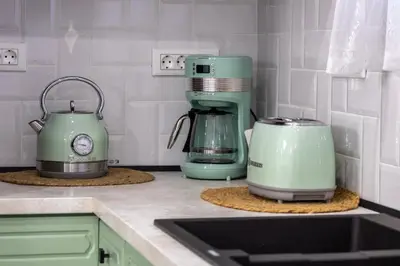 a kitchen with green appliances on a counter at maison de rivière in Afantou