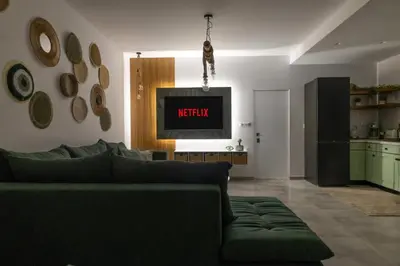 a living room with a couch and a tv at maison de rivière in Afantou