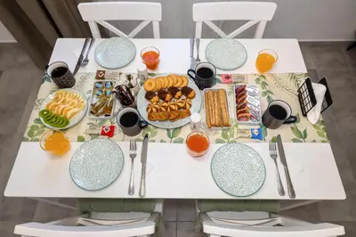 a table with food and drinks on it at maison de rivière in Afantou