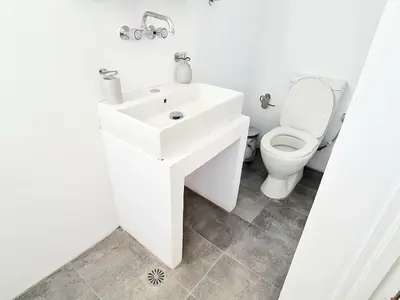 a bathroom with a white sink and a toilet at Piccolo Modern Suites - Old Town in Rhodes Town