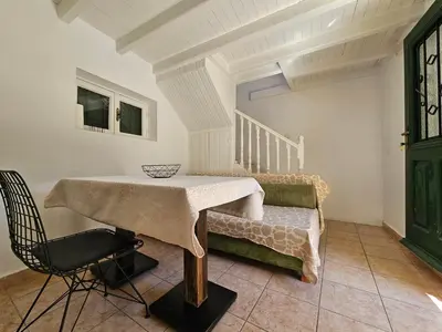 a dining room with a table and a chair at Piccolo Modern Suites - Old Town in Rhodes Town