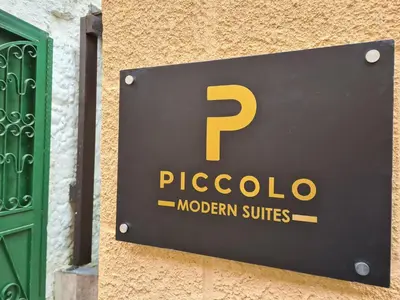 a sign on the side of a building at Piccolo Modern Suites - Old Town in Rhodes Town