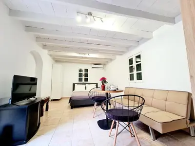 a living room with a couch and a bed at Piccolo Modern Suites - Old Town in Rhodes Town