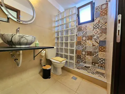 a bathroom with a sink and a toilet and a mirror at Anastazia Apartments - Rhodes City in Rhodes Town