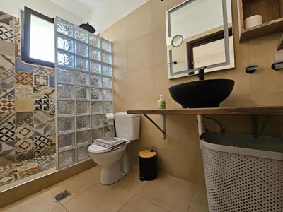 a bathroom with a toilet and a sink and a mirror at Anastazia Apartments - Rhodes City in Rhodes Town