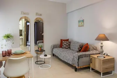 a living room with a couch and a table at Anastazia Apartments - Rhodes City in Rhodes Town