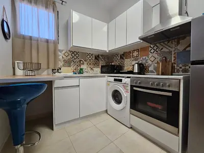 a kitchen with a washer and a washing machine at Anastazia Apartments - Rhodes City in Rhodes Town
