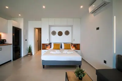 a bedroom with a large bed with yellow pillows at Aelios Petra sea view apartment 3 in Asgourou