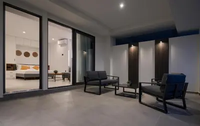 a living room with two chairs and a couch at Aelios Petra sea view apartment 3 in Asgourou