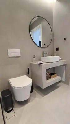 a bathroom with a toilet and a sink and a mirror at Aelios Petra sea view apartment 3 in Asgourou
