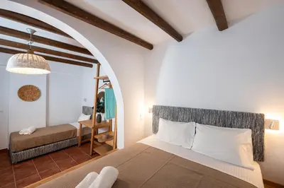 a bedroom with a bed and a chair in a room at Villa Salamina in Lachania