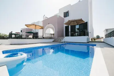 a swimming pool in front of a villa at Villa Irini & Villa Vasiliki in Afantou