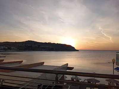 a group of boats on the water at sunset at Haraki Aqua Marine in Haraki