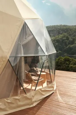 a man sitting in a tent on a deck at Dawn To Dusk Sea and Mountain View in Kamiros