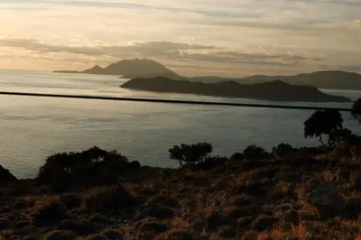 a view of the ocean with mountains in the background at Dawn To Dusk Sea and Mountain View in Kamiros