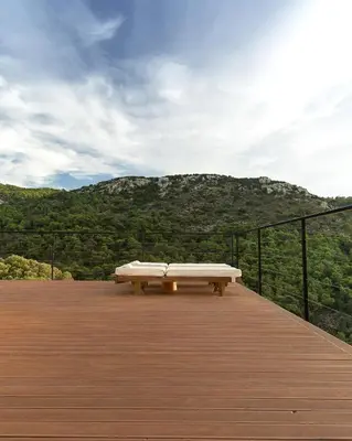 a bench sitting on top of a wooden deck at Dawn To Dusk Sea and Mountain View in Kamiros