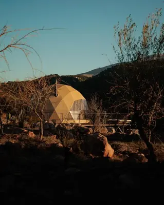 a large dome tent in a field with trees at Dawn To Dusk Sea and Mountain View in Kamiros