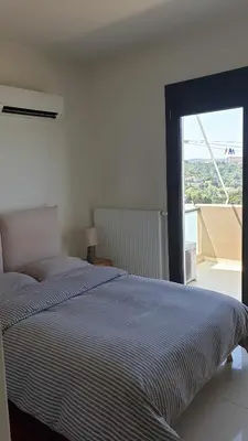 a bedroom with a bed and a large window at Sea View Apartment in Rhodes Town