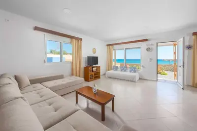 a living room with a couch and a table at The Rhodes South Escape Beach in Plimmiri