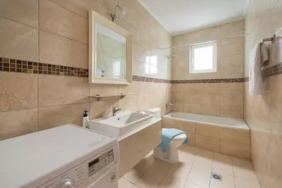 a bathroom with a sink and a toilet and a tub at The Rhodes South Escape Beach in Plimmiri