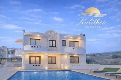a white house with a swimming pool in front of it at Kalithea Sunrise in Rhodes Town