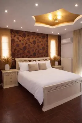 a bedroom with a large white bed with a ceiling at Kalithea Sunrise in Rhodes Town
