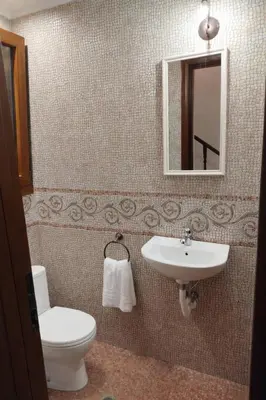 a bathroom with a toilet and a sink and a mirror at Kalithea Sunrise in Rhodes Town