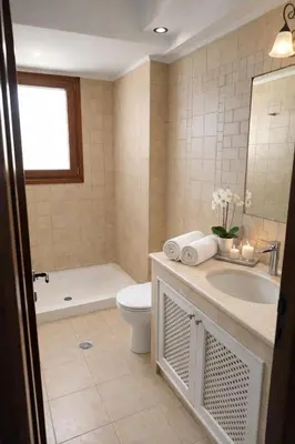 a bathroom with a sink and a toilet and a tub at Kalithea Sunrise in Rhodes Town