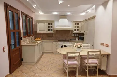 a kitchen with a table and chairs in it at Kalithea Sunrise in Rhodes Town