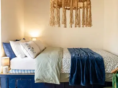 a bedroom with a bed with pillows on it at Heritage House Malonas in Malona Village